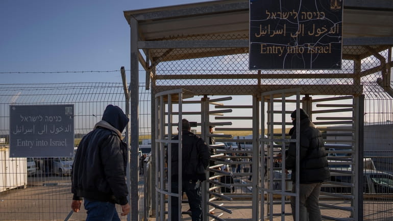 Palestinian workers enter Israel after crossing from Gaza on the...