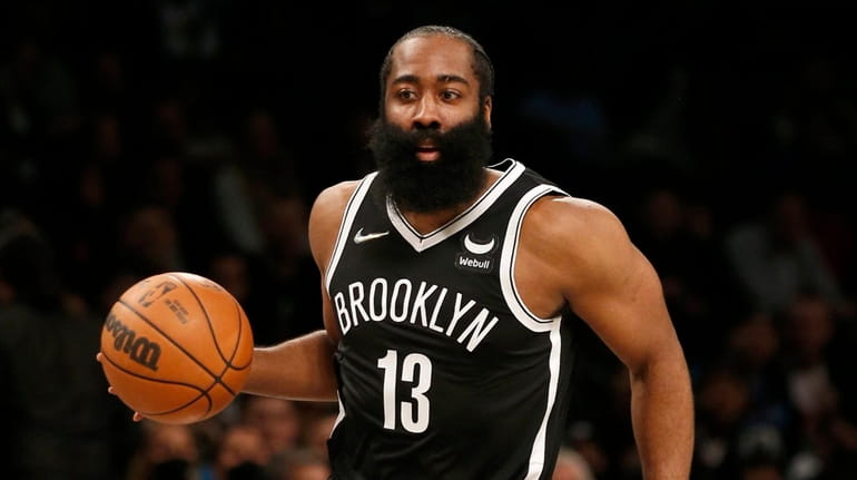 James Harden #13 of the Nets controls the ball in...