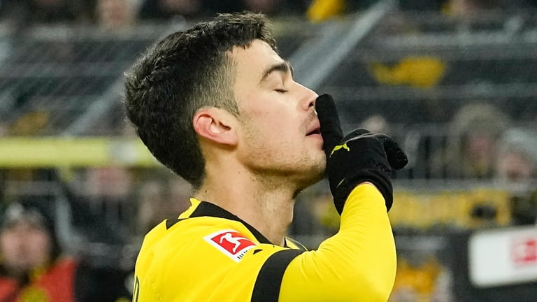 Dortmund's Giovanni Reyna celebrates scoring his side's fourth goal during...
