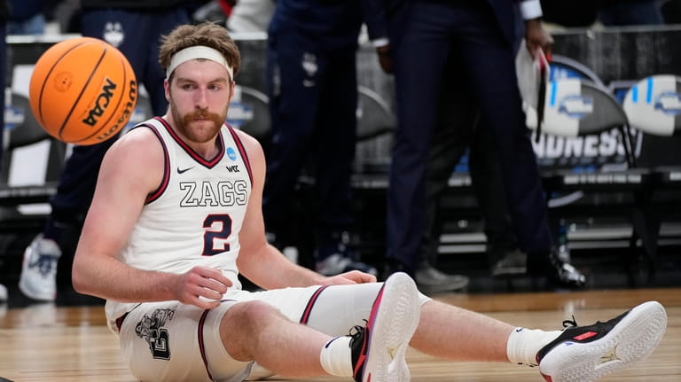 Gonzaga forward Drew Timme (2) sits on the floor after...