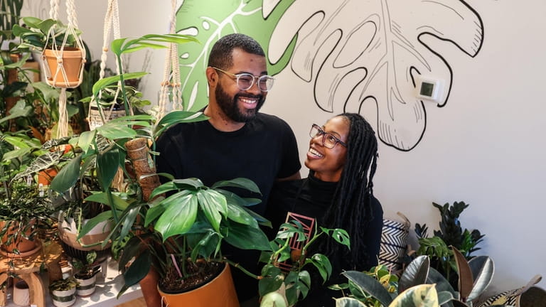 Kandice Rogers, with a mini monstera plant and her husband, Aaron...