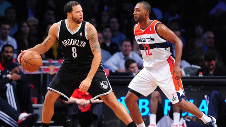 Deron Williams of the Brooklyn Nets is guarded by A...