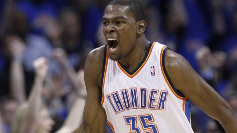 Oklahoma City Thunder forward Kevin Durant reacts after scoring against...