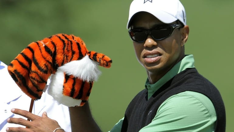 Tiger Woods of the US takes a club at the...