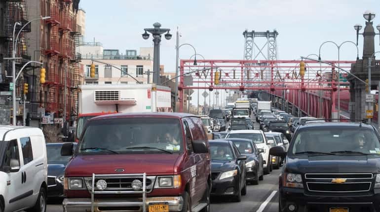 Vehicles arrive in Manhattan after crossing the Williamsburg Bridge in Manhattan...