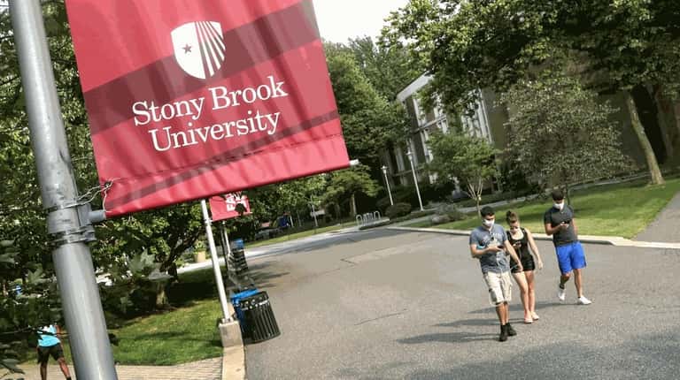 Students walk through the Stony Brook University campus on Aug. 27,...
