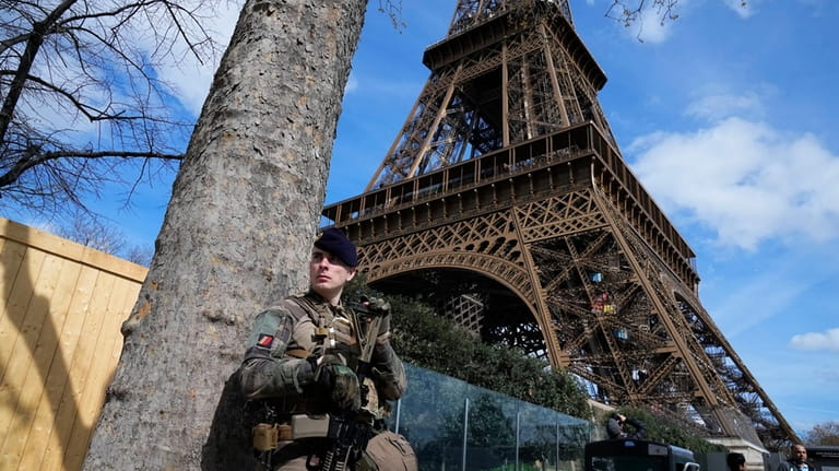 A soldier patrols at the Eiffel Tower, Monday, March 25,...