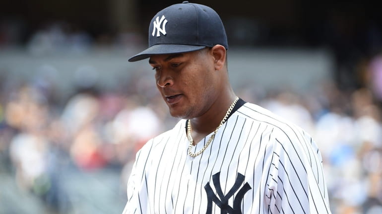 New York Yankees starting pitcher Ivan Nova walks to the...