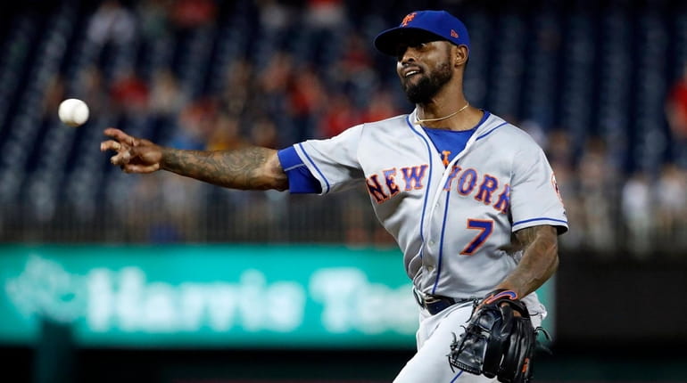 Mets shortstop Jose Reyes pitches in relief during the eighth...