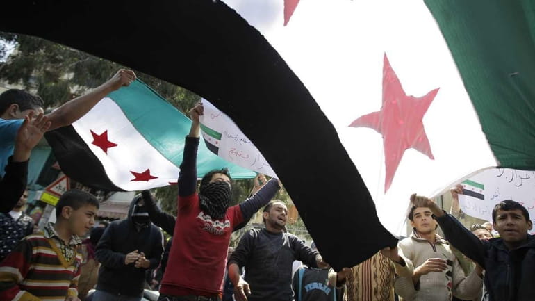 Lebanese protesters wave pre-Baath Syrian flags during a demonstration against...