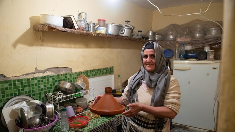 Fatima Barri, 57, prepares food to break her Ramadan fast...