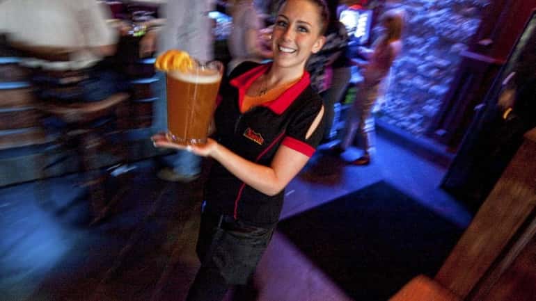 Server Ashley Brady delivers a pitcher of Blue Moon beer...