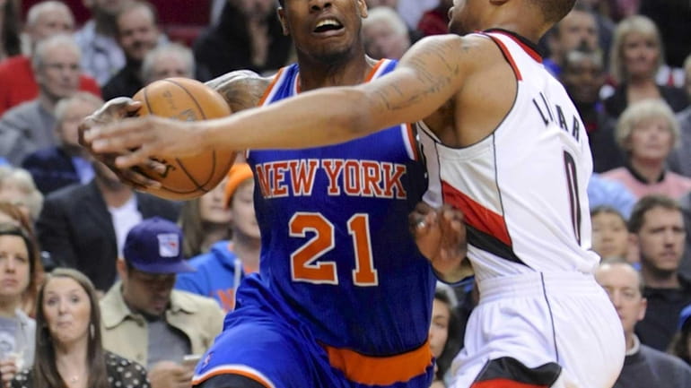 Knicks' Iman Shumpert drives against Portland Trail Blazers' Damian Lillard...