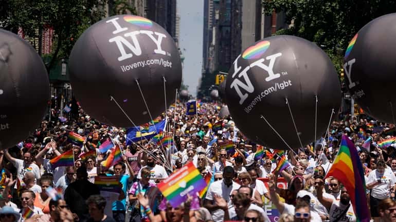 Participants in the NYC Pride March make their way down...