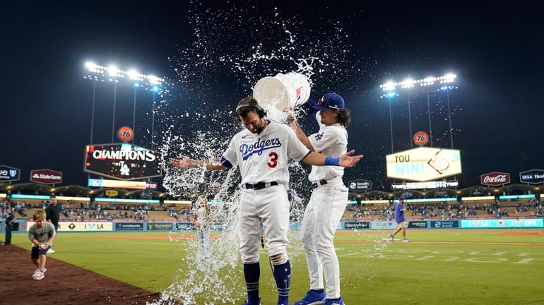 Los Angeles Dodgers' Chris Taylor (3) is doused with water...