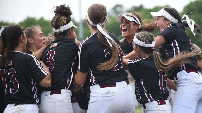 Mepham teammates celebrate after a home run by Dominique DeLutri...