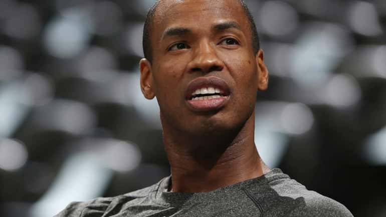 Nets center Jason Collins rests in a courtside seat after...