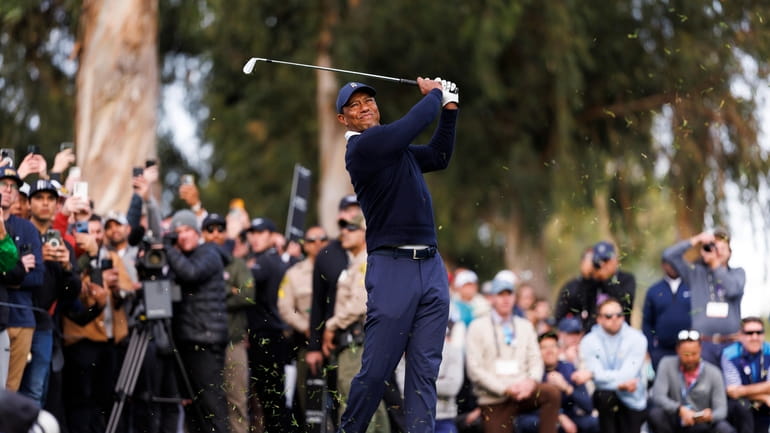 FILE - Tiger Woods hits his second shot on the...