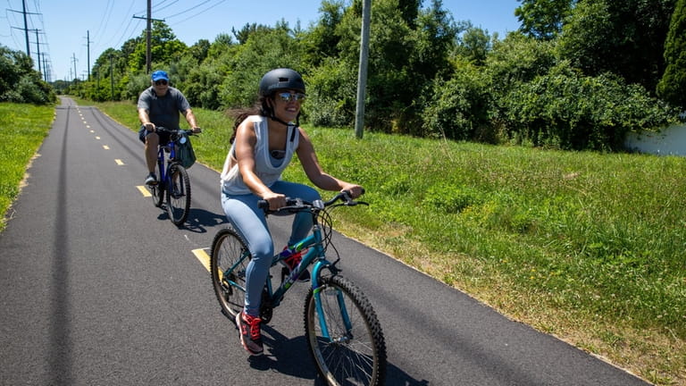 Joe Lacobara, left, and Megan Lacobara, of Connecticut, ride bikes...