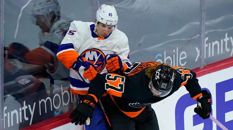 The Flyers' Wade Allison and Islanders' Braydon Coburn collide during...