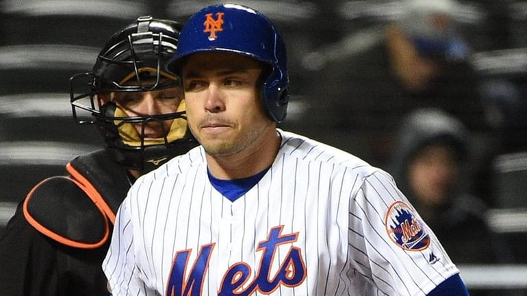 New York Mets catcher Travis d'Arnaud reacts after he strikes...