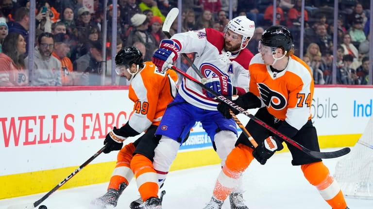 Montreal Canadiens' Joel Edmundson (44) battles for the puck against...