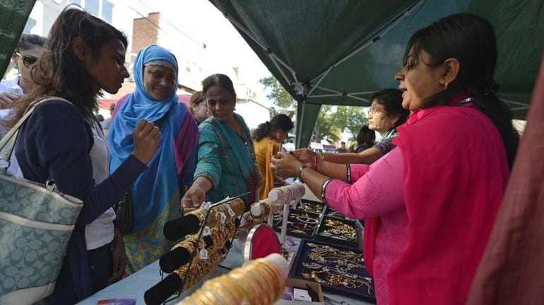 An Indian street fair in Jackson Heights includes wares such...