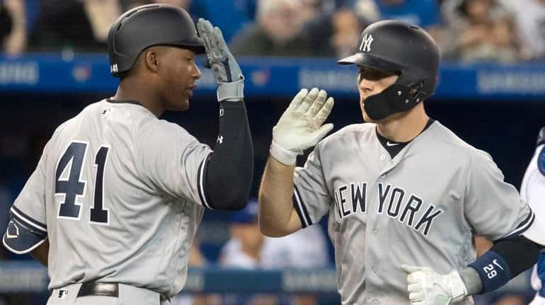 Yankees' Brandon Drury, right, celebrates his two-run home run against...