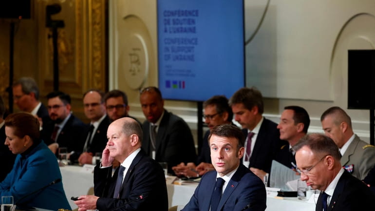 French President Emmanuel Macron, center right, delivers a speech at...