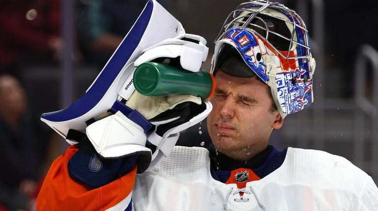 Ilya Sorokin #30 of the New York Islanders sprays his...
