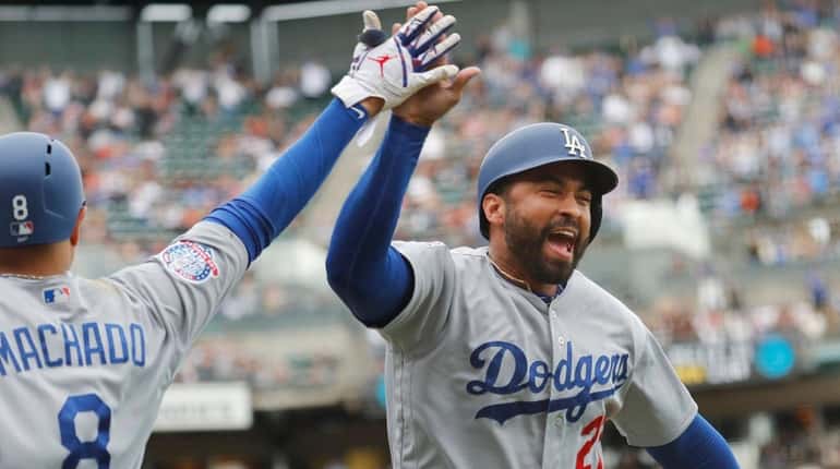 Los Angeles Dodgers' Matt Kemp celebrates with Manny Machado after...