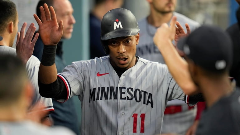 Minnesota Twins' Jorge Polanco (11) celebrates in the dugout after...