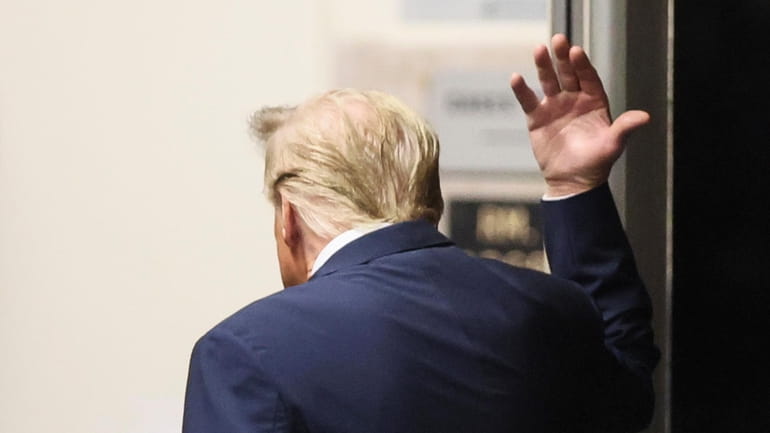 Former President Donald Trump gestures Tuesday as he walks into...