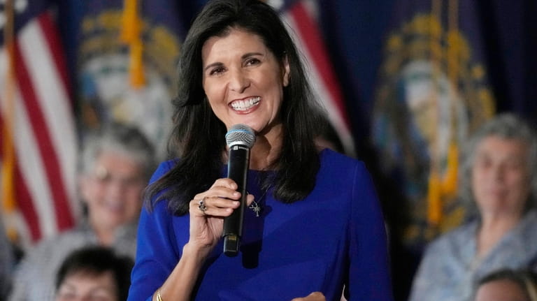 Republican presidential candidate Nikki Haley smiles while taking a question...