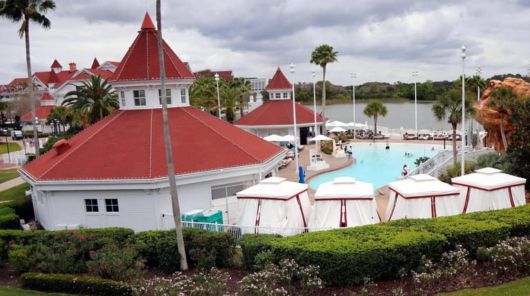 People swim in the pool at Disney's Grand Floridian Resort...