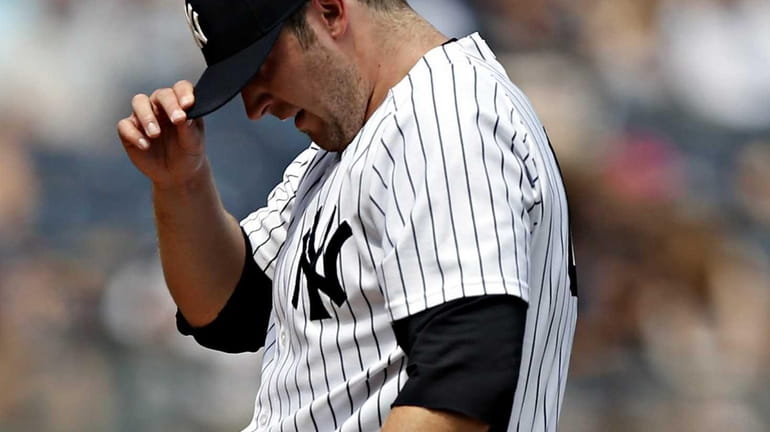Yankees starting pitcher Phil Hughes takes a breather in the...