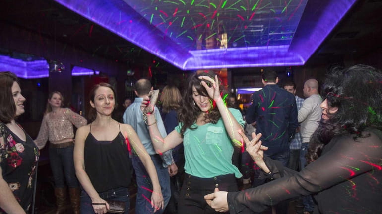 Patrons dance during a late-night party at Acacia in Huntington...