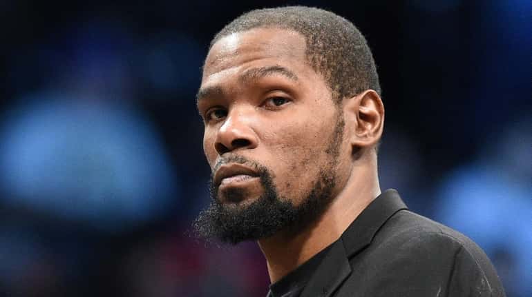 Nets' Kevin Durant looks on during a timeout in the...