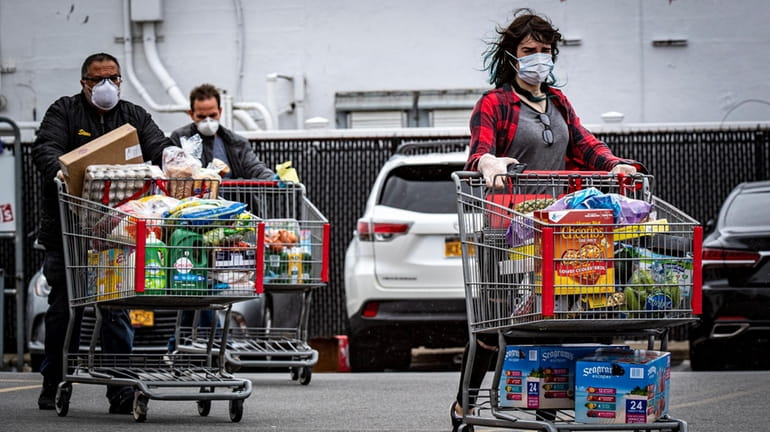 People wearing masks while shopping at BJ's in Freeport on...