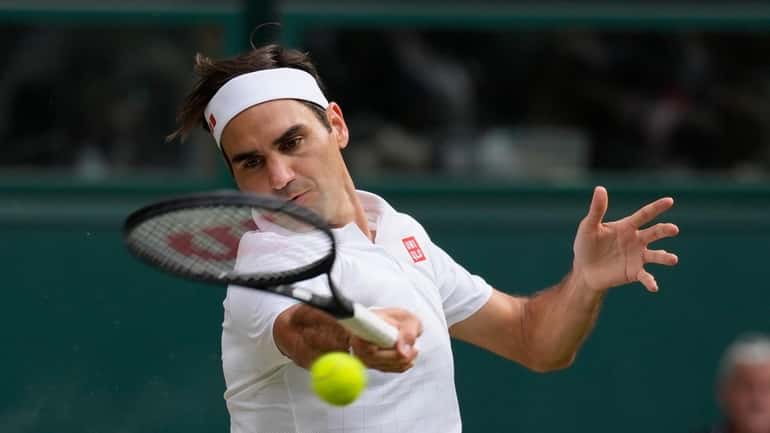 Roger Federer plays a return to Hubert Hurkacz during a...