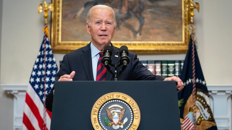 President Joe Biden talks with reporters after delivering remarks on...