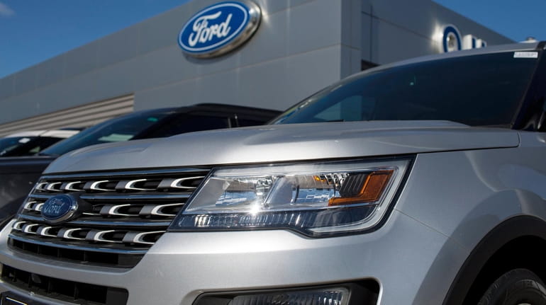 Vehicles at a Ford dealer in Quincy, Mass., are shown in...