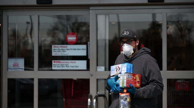 A man exits a Hicksville Target store with groceries on...