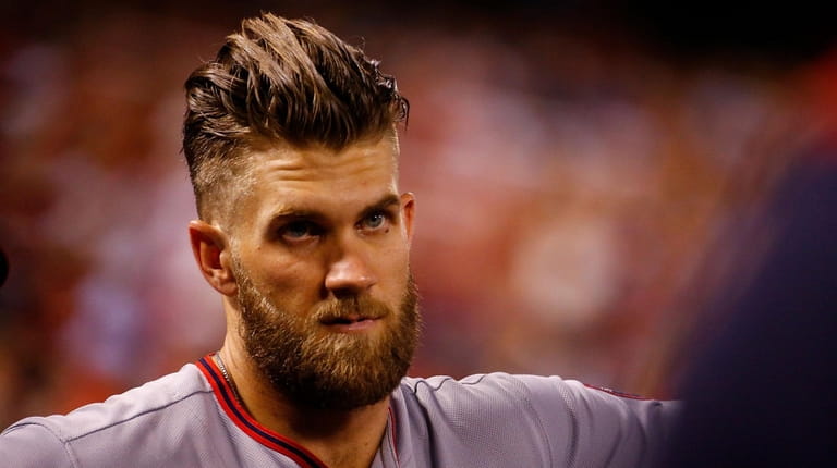 Bryce Harper looks on from the dugout during a game...