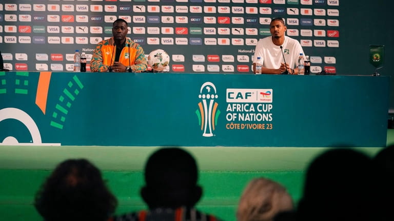 Ivory Coast's interim Soccer coach Emerse Fae, left, Sebastien Haller,...