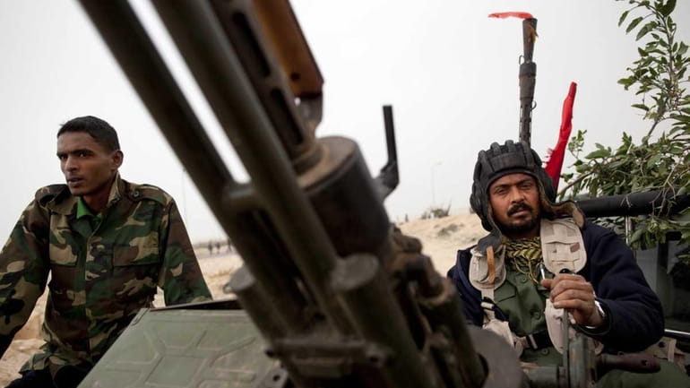 Libyan rebels who are part of the forces against Libyan...