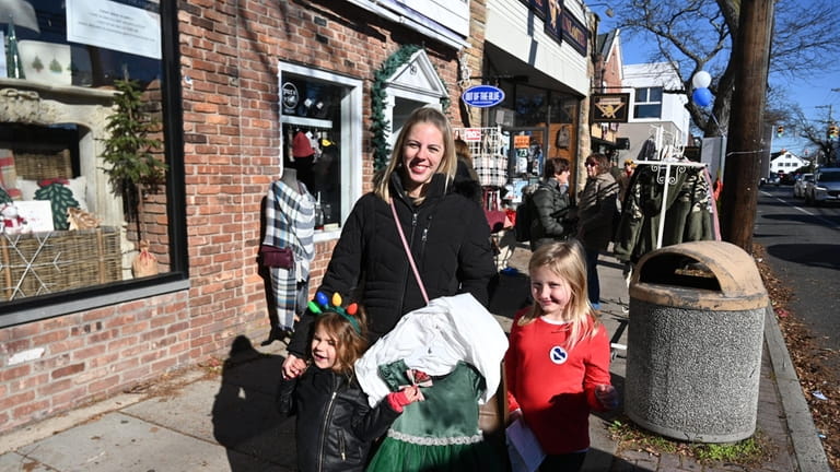 Dana Sweet with her daughters Mackenzie, left, and Alexis on Main Street...