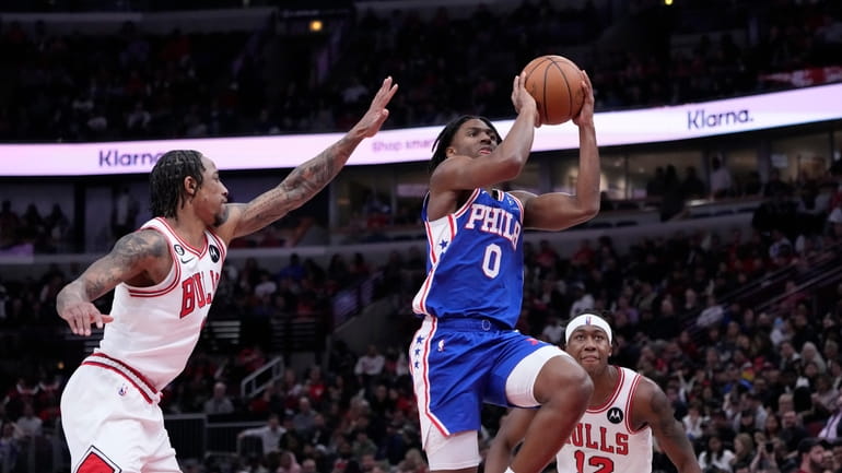 Philadelphia 76ers' Tyrese Maxey drives to the basket past Chicago...