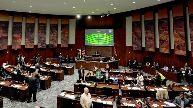 Arizona state representatives convene on House floor at the Capitol,...