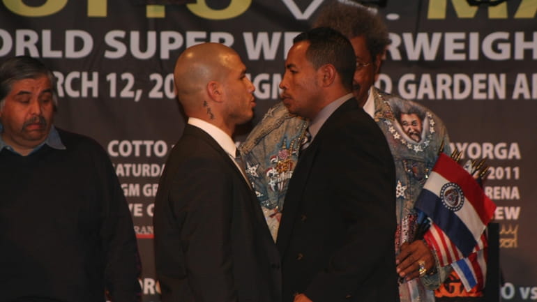 Miguel Cotto and Ricardo Mayorga stand face to face at...